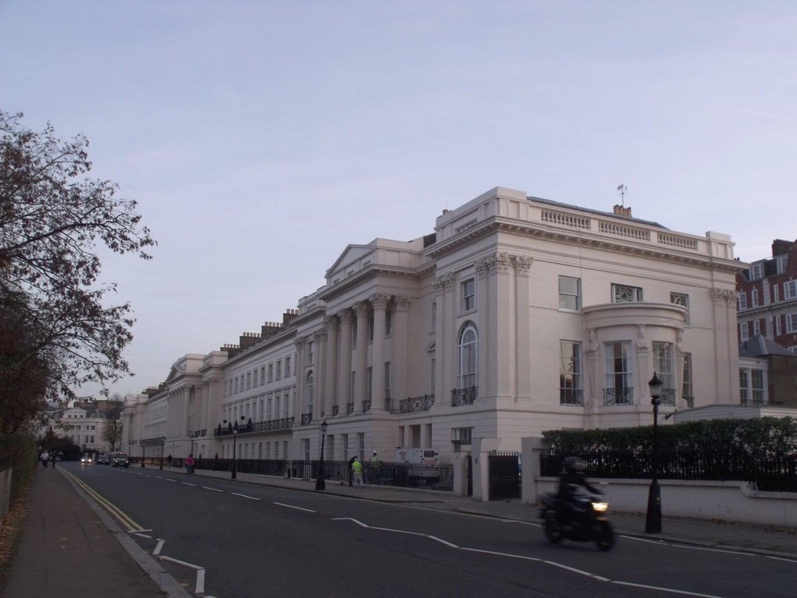 A London stucco-fronted terrace with columned entrances and railings, seen along the street