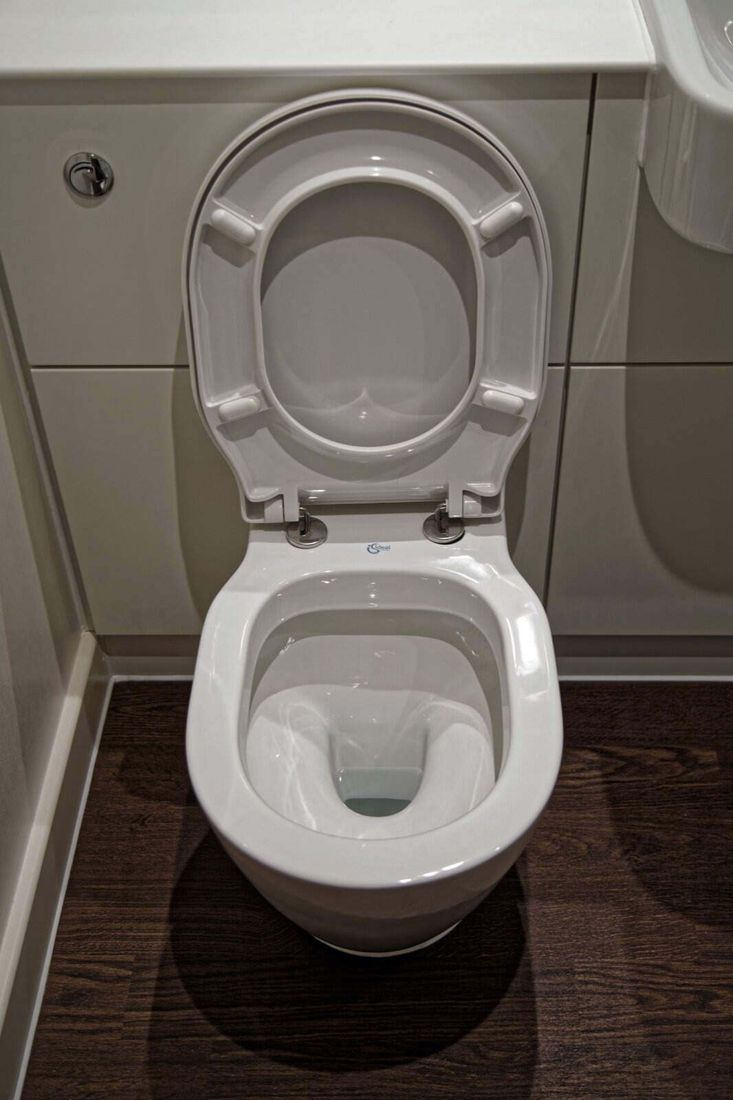 A white back-to-wall toilet with the cistern hidden behind a fitted unit in a modern bathroom