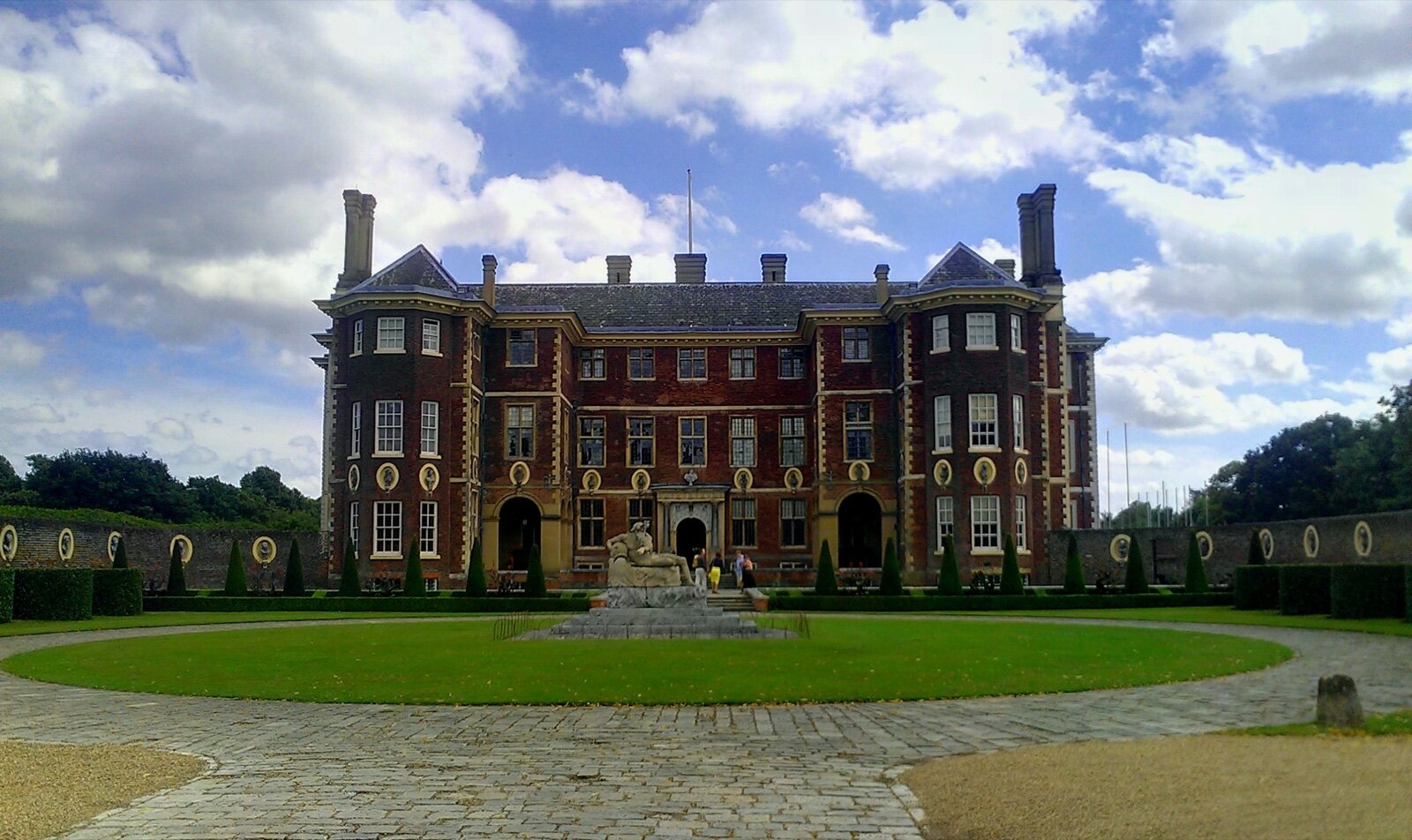 The red brick south front of Ham House in Richmond seen across its formal forecourt