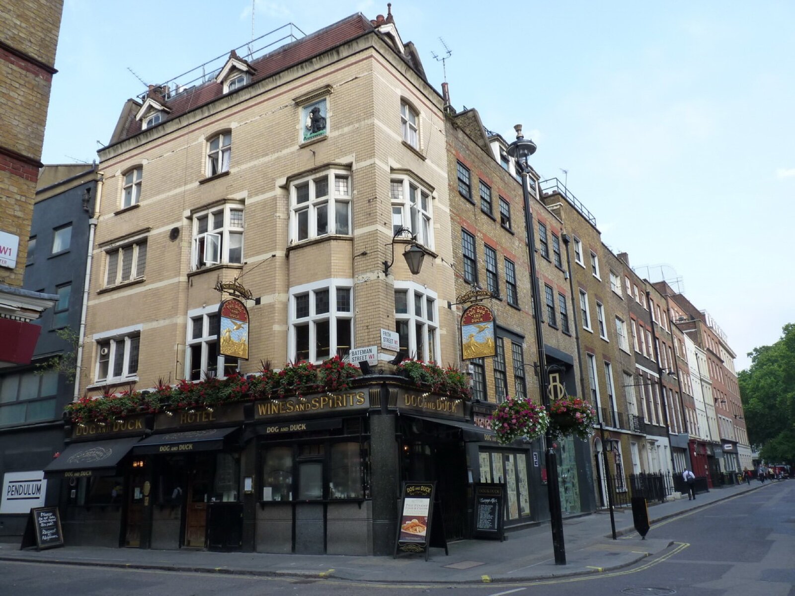Brick and stone terraced buildings at the corner of Frith Street and Bateman Street in Soho, with the Dog and Duck pub on the corner