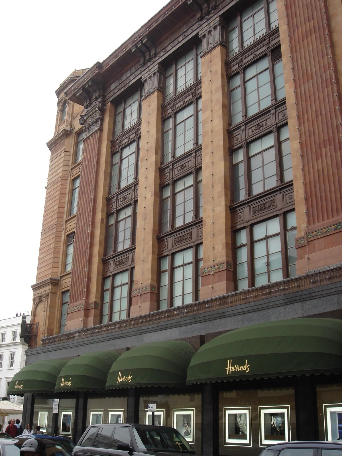 Terracotta facade of Harrods with green awnings on Brompton Road, Knightsbridge